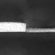 A microscopic image of paint applied in two different thicknesses.